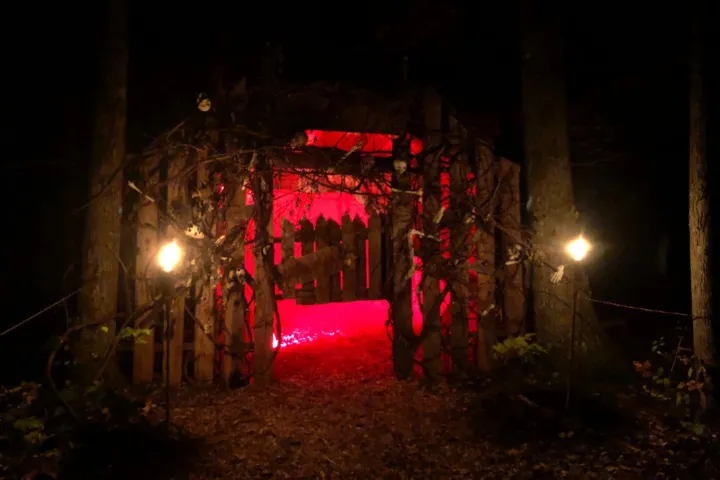 Red-lit entrance to the Zombie Zips haunted terror trail at NYzipline in Schenectady, NY.