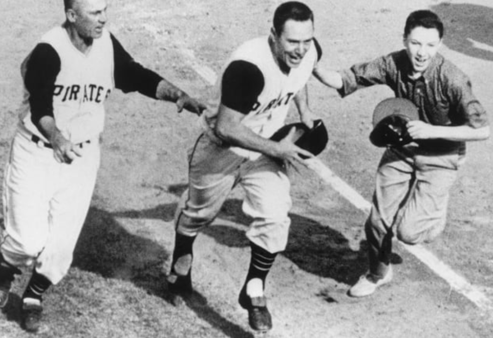 Three jubilant baseball players celebrating on field.